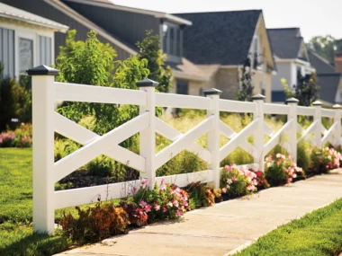 Front yard with cross ranch rail white vinyl fence