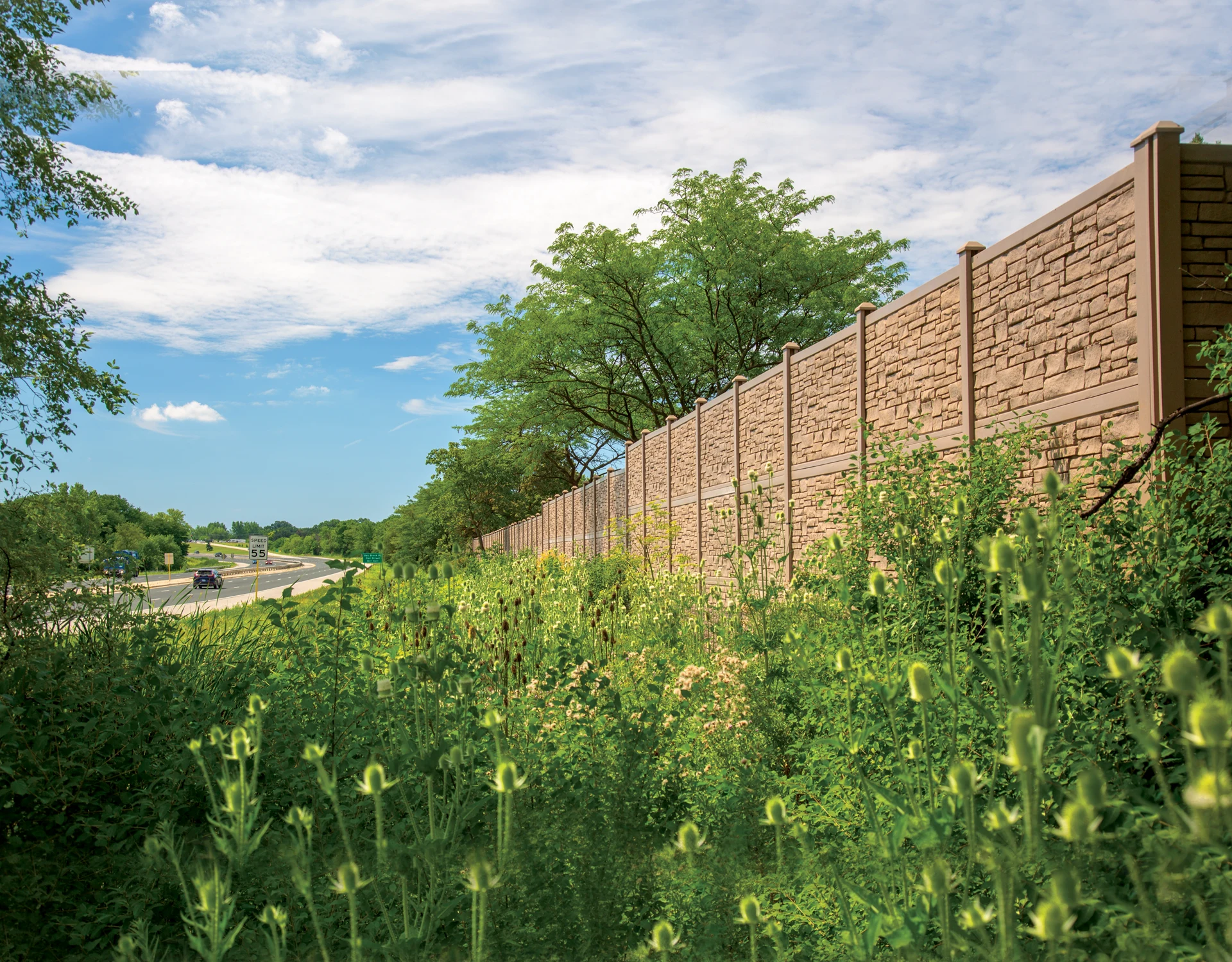 Boulder fence in Brown Granite along highway