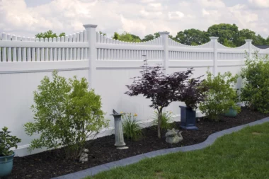 Somerset open spindle top privacy fence in white along planter bed