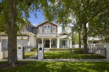 Orleans finial top picket fence around front yard with arched gate on walk way