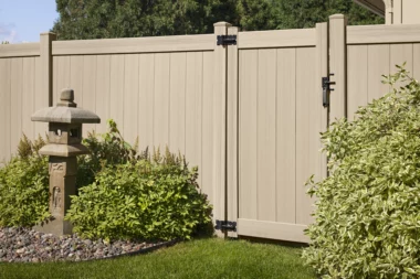Newbury solid vertical privacy fence with gate and along planter beds