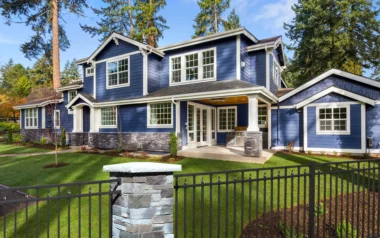 Salem alternating spear picket fence in black around back yard with stone pillars