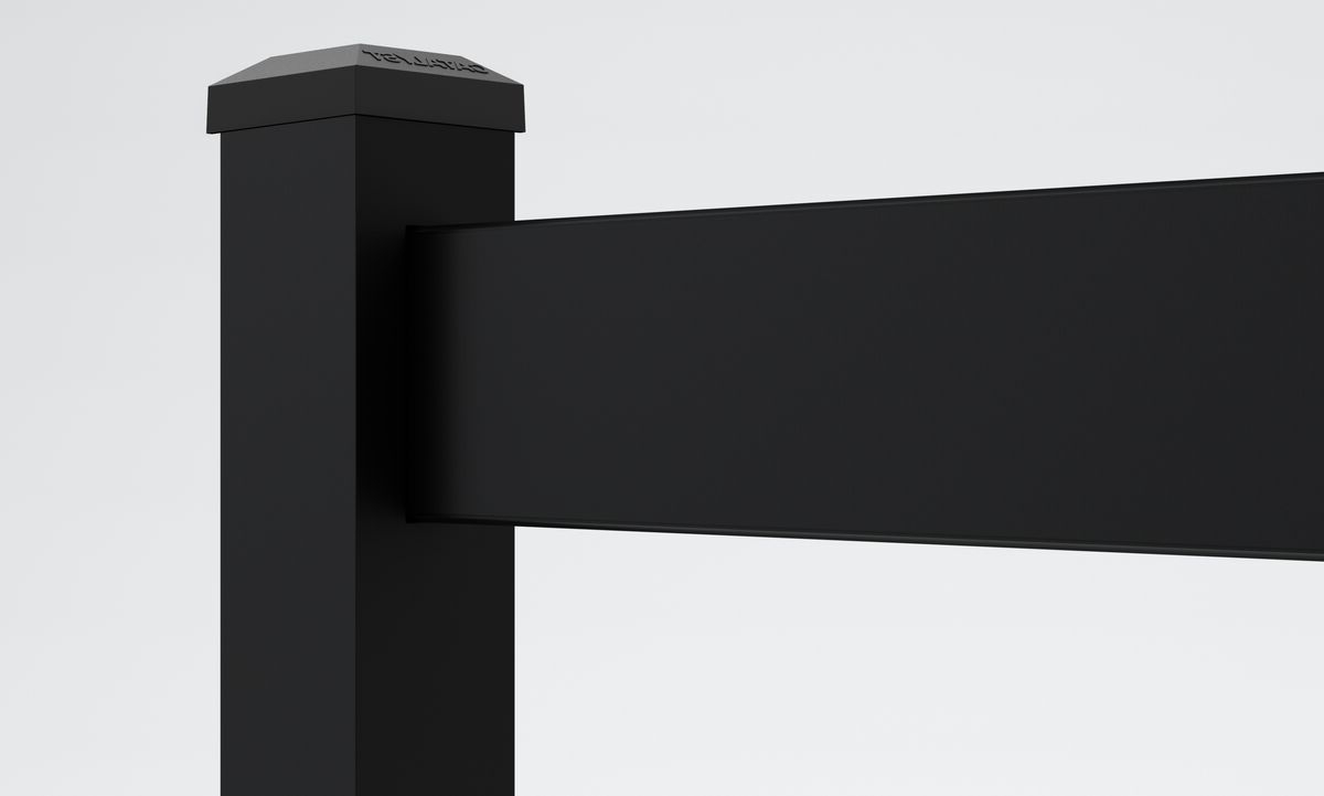 Close-up of a black rectangular fence post with a horizontal rail attached, set against a plain white background. The top of the post has a cap with subtle embossed text.
