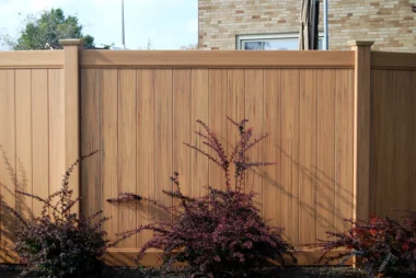 straight on view of wood texture brown vinyl privacy fence