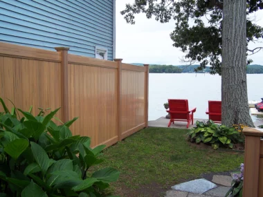 Newbury solid vertical privacy fence along lake property line