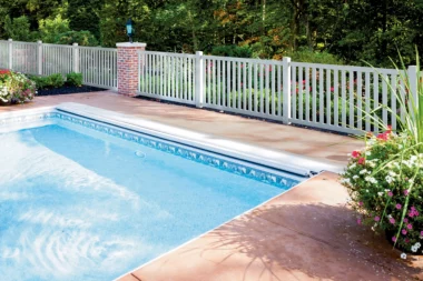 Norwalk closed picket fence in white around homes pool area