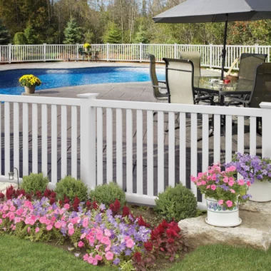 Norwalk closed picket fence in white around homes pool area with flowers