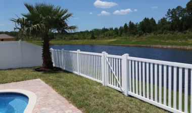 Norwalk closed picket fence with gate in white around homes pool area