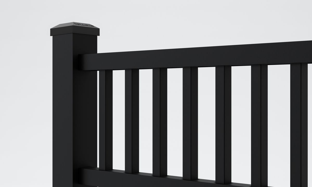 A close-up view of a modern black metal fence with vertical slats and a thick square post on the right side against a plain light background.