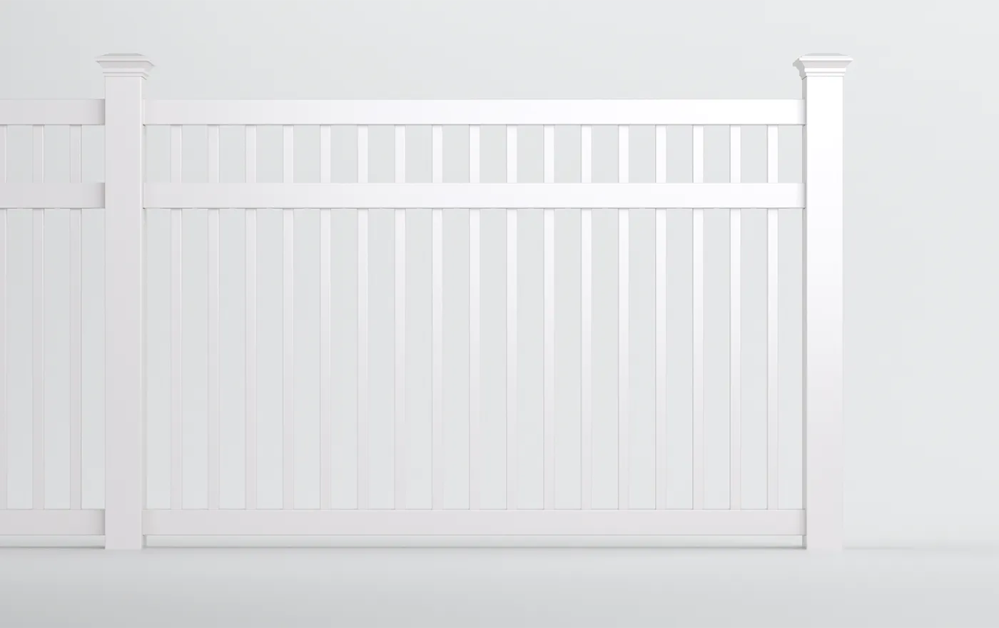 A white, vertical slatted fence panel with decorative top accents and sturdy posts, set against a plain light gray background.