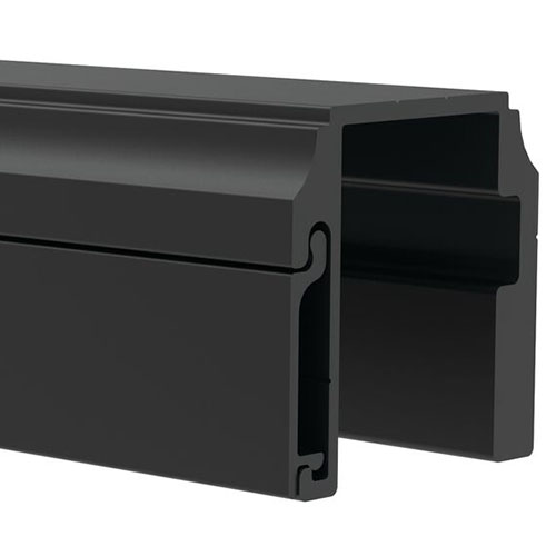 A close-up of a black, rectangular aluminum extrusion profile with a hollow center and grooved channels, commonly used in construction or framing applications.