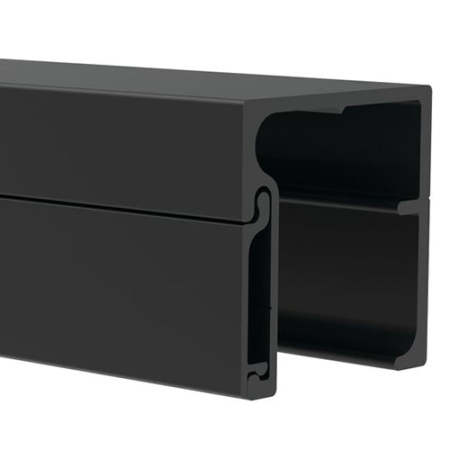 Close-up view of a black, rectangular aluminum extrusion profile with a hollow center and grooves along the edges, commonly used in construction or framing applications.