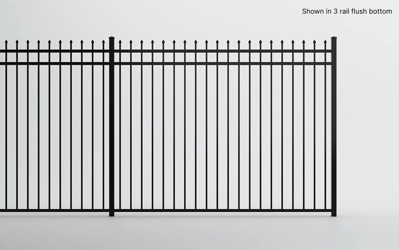 Black metal fence with vertical bars and evenly spaced finials on top. The design includes three horizontal rails, with a flush bottom rail. The background is a plain, light gray surface.