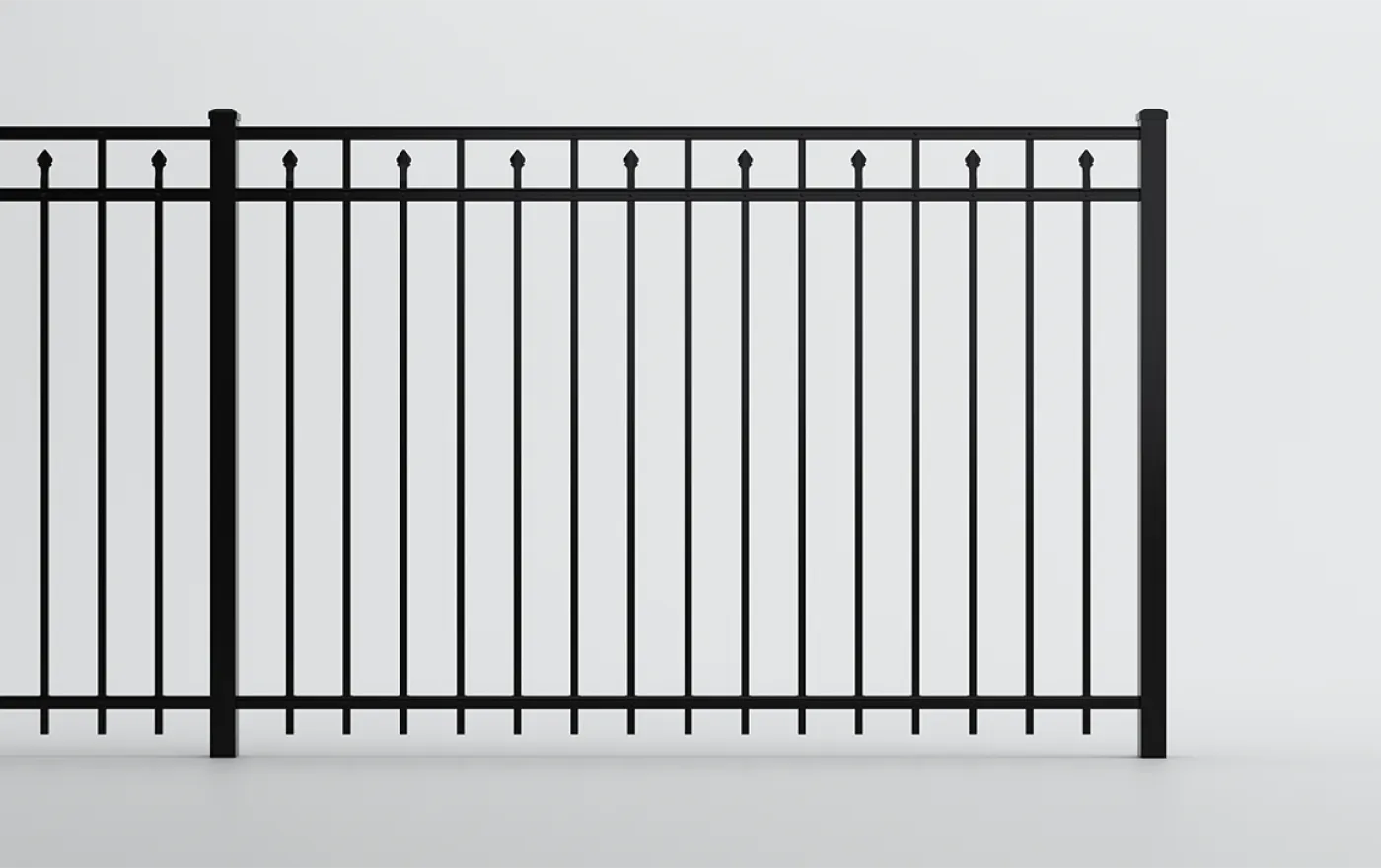 Black metal fence with vertical bars and pointed finials at the top, set against a plain white background.