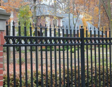 Orleans finial top picket fence with brick pillars around front yard