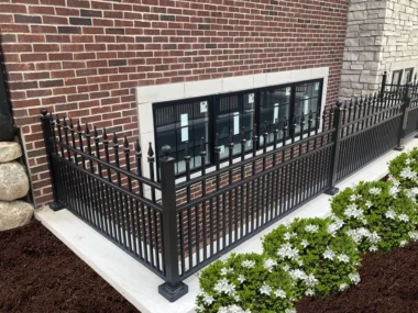 Orleans finial top picket fence around egress window space