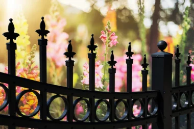 black aluminum picket fence with decorative finials and circle adornments