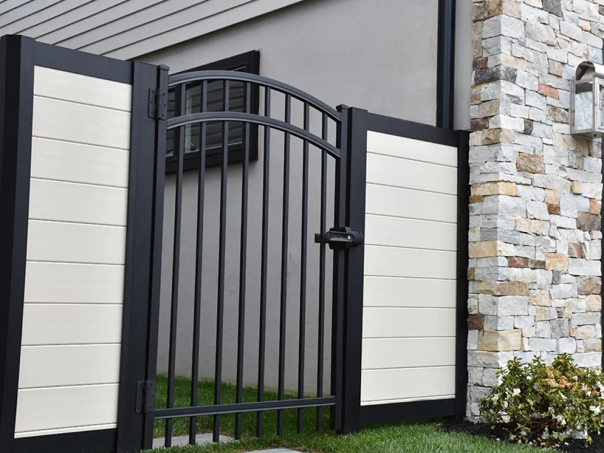 mixed material fence with black metal gate