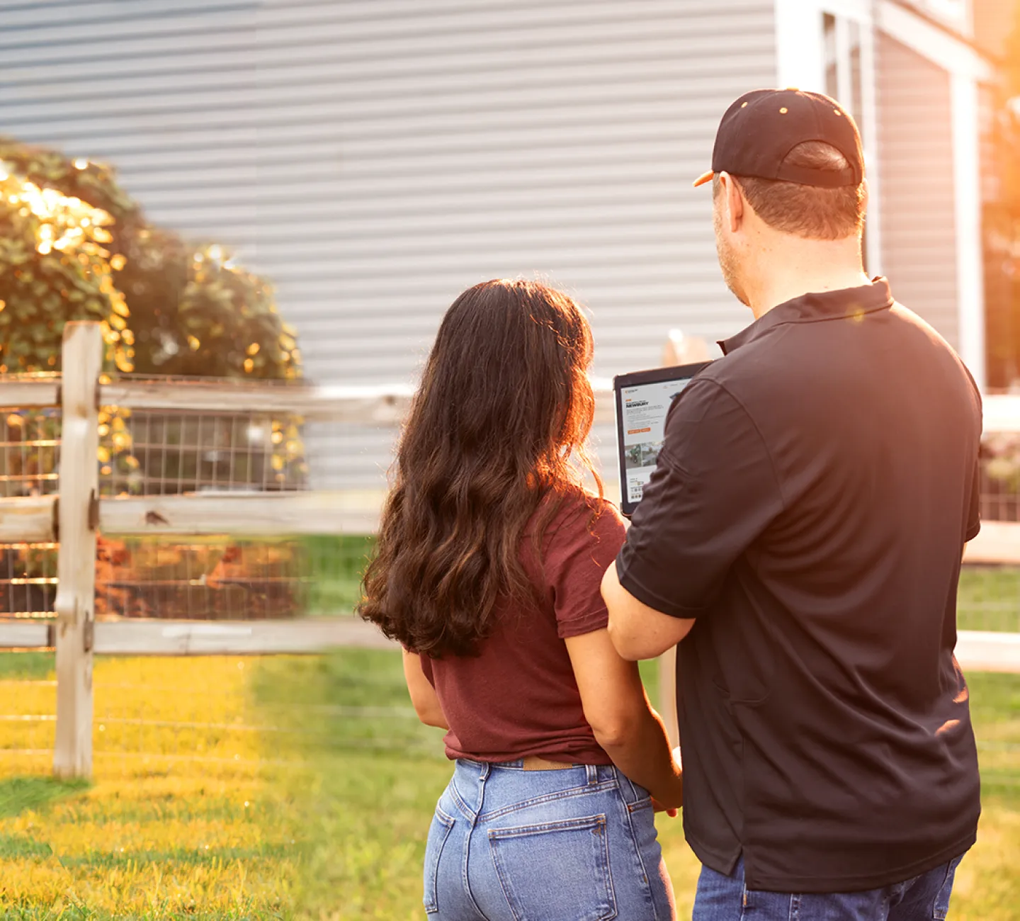 Fence professional reviewing options with a homeowner on a tablet